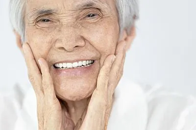 woman smiling after getting dental crowns from Smile Studio Upland