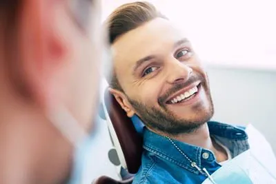 man smiling during his first visit to Smile Studio Dentistry in Upland, CA